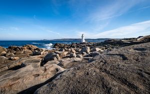 Preview wallpaper lighthouse, rocks, stones, sea, clouds, nature
