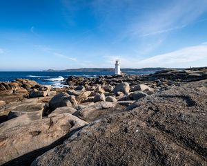 Preview wallpaper lighthouse, rocks, stones, sea, clouds, nature