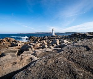 Preview wallpaper lighthouse, rocks, stones, sea, clouds, nature