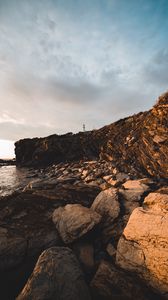 Preview wallpaper lighthouse, rocks, stones, cliff