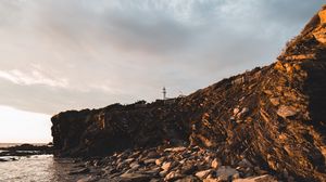 Preview wallpaper lighthouse, rocks, stones, cliff