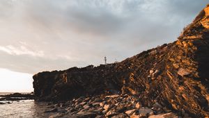 Preview wallpaper lighthouse, rocks, stones, cliff