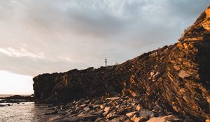 Preview wallpaper lighthouse, rocks, stones, cliff