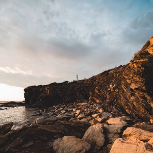 Preview wallpaper lighthouse, rocks, stones, cliff