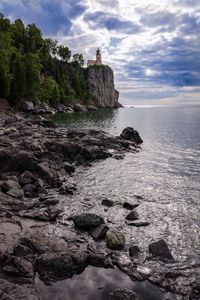 Preview wallpaper lighthouse, sea, cliff, rock, shore