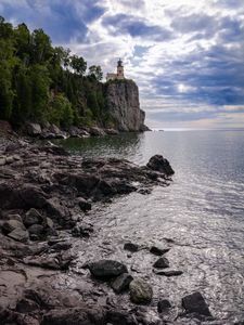 Preview wallpaper lighthouse, sea, cliff, rock, shore