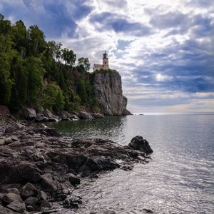 Preview wallpaper lighthouse, sea, cliff, rock, shore