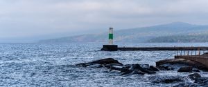 Preview wallpaper lighthouse, sea, coast, stones, waves