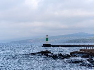 Preview wallpaper lighthouse, sea, coast, stones, waves