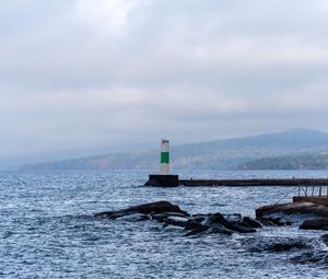 Preview wallpaper lighthouse, sea, coast, stones, waves