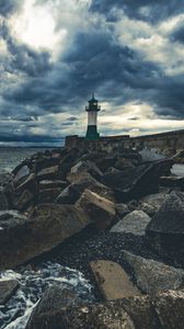 Preview wallpaper lighthouse, sea, coast, stones, clouds