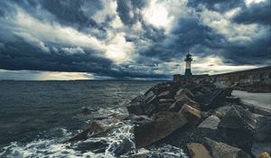 Preview wallpaper lighthouse, sea, coast, stones, clouds
