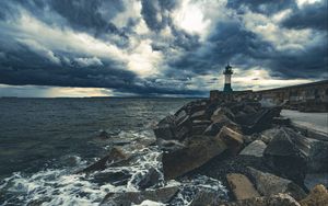 Preview wallpaper lighthouse, sea, coast, stones, clouds