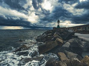 Preview wallpaper lighthouse, sea, coast, stones, clouds