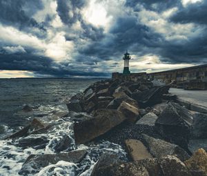 Preview wallpaper lighthouse, sea, coast, stones, clouds