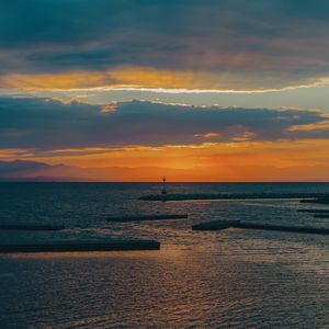Preview wallpaper lighthouse, sea, pier, horizon, sunset