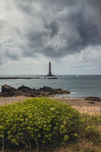 Preview wallpaper lighthouse, sea, shore, bush, stones