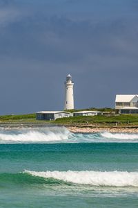 Preview wallpaper lighthouse, sea, waves, buildings