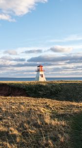 Preview wallpaper lighthouse, shore, grass, sky, sea