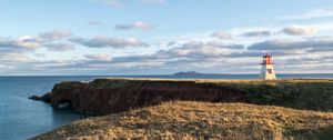 Preview wallpaper lighthouse, shore, grass, sky, sea