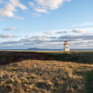 Preview wallpaper lighthouse, shore, grass, sky, sea