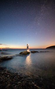 Preview wallpaper lighthouse, starry sky, sea, penmon, united kingdom