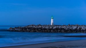 Preview wallpaper lighthouse, stones, sea, shore, sky