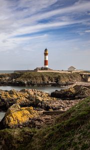 Preview wallpaper lighthouse, stones, sea, sky, nature