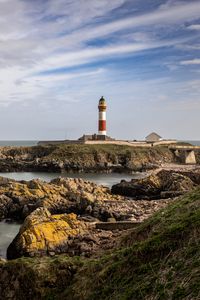 Preview wallpaper lighthouse, stones, sea, sky, nature