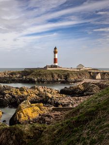 Preview wallpaper lighthouse, stones, sea, sky, nature