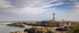 Preview wallpaper lighthouse, stones, sea, sky, nature