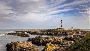 Preview wallpaper lighthouse, stones, sea, sky, nature