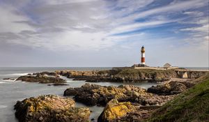 Preview wallpaper lighthouse, stones, sea, sky, nature