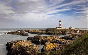 Preview wallpaper lighthouse, stones, sea, sky, nature