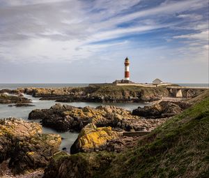 Preview wallpaper lighthouse, stones, sea, sky, nature