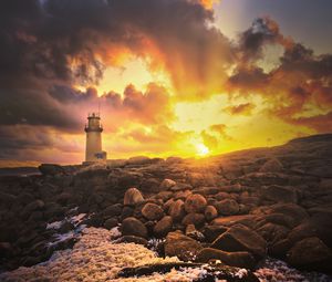 Preview wallpaper lighthouse, stones, shore, clouds