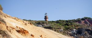 Preview wallpaper lighthouse, stones, slope, sky