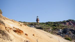 Preview wallpaper lighthouse, stones, slope, sky
