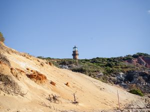 Preview wallpaper lighthouse, stones, slope, sky