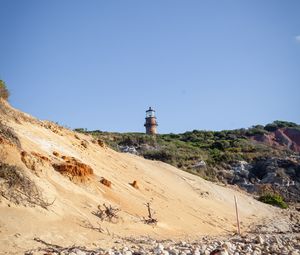 Preview wallpaper lighthouse, stones, slope, sky