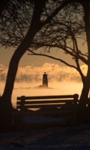 Preview wallpaper lighthouse, sunset, bench, blur, trees, branches