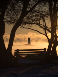 Preview wallpaper lighthouse, sunset, bench, blur, trees, branches