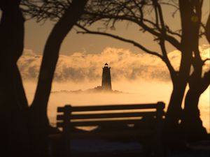 Preview wallpaper lighthouse, sunset, bench, blur, trees, branches