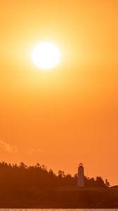 Preview wallpaper lighthouse, sunset, sun, shore, dusk