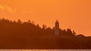 Preview wallpaper lighthouse, sunset, sun, shore, dusk
