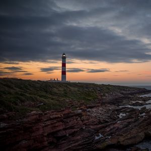 Preview wallpaper lighthouse, tower, cliff, twilight