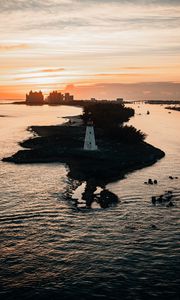 Preview wallpaper lighthouse, tower, island, sea, buildings, sunset