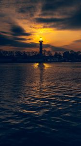 Preview wallpaper lighthouse, tower, light, water, trees, twilight, dark