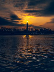 Preview wallpaper lighthouse, tower, light, water, trees, twilight, dark