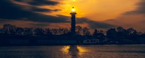 Preview wallpaper lighthouse, tower, light, water, trees, twilight, dark